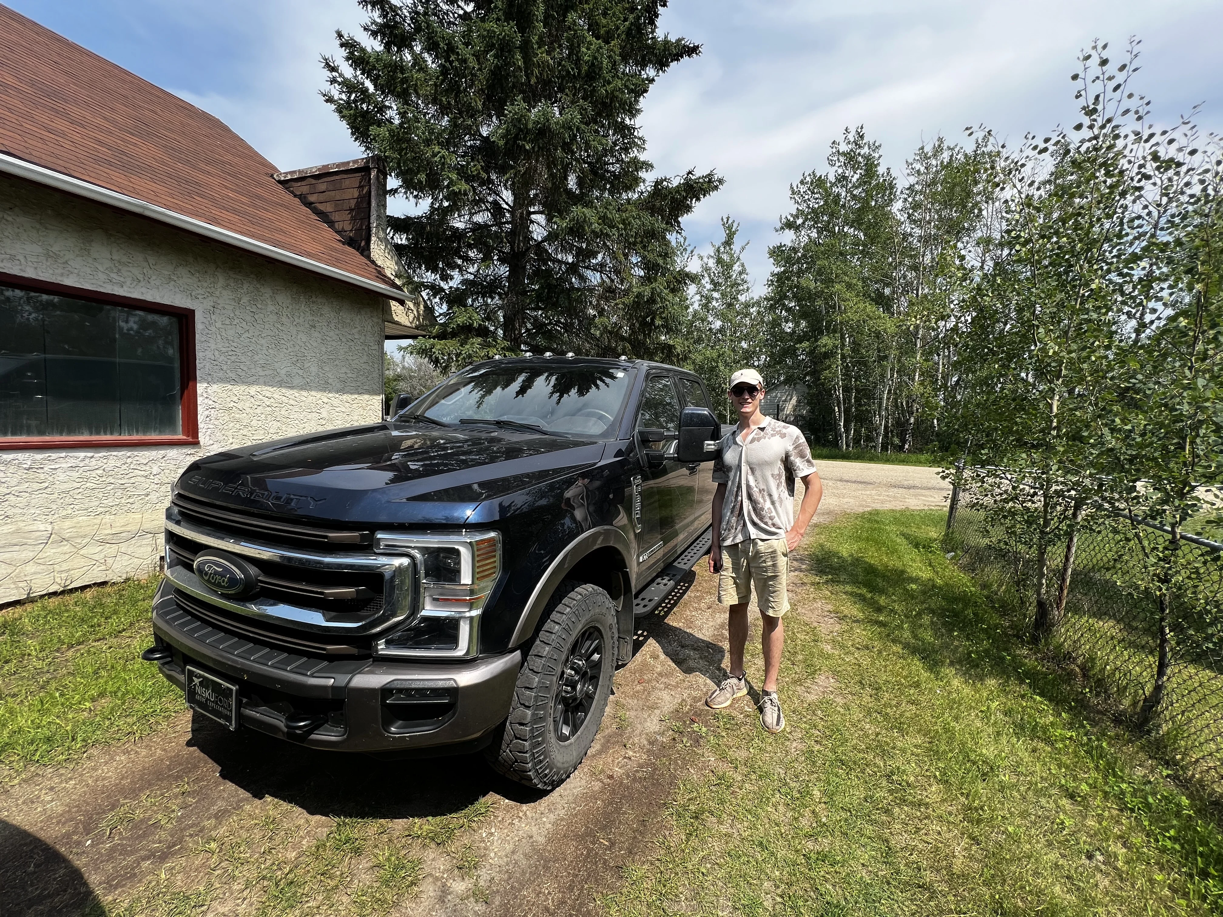 Ryan standing next to a large Ford truck